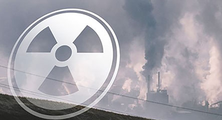 an image of a nuclear facility with a translucent radiation symbol in front